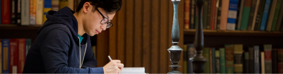 Student studying in a library. 