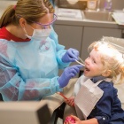 student treating a young patient. 