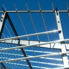 The metal framework of the Murchie Fieldhouse on UB's north campus, reflecting the sunlight as it is being built. 