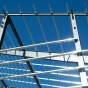 The metal framework of the Murchie Fieldhouse on UB's north campus, reflecting the sunlight as it is being built. 