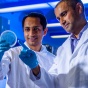 Researchers looking at a sample in a lab. 