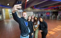 People taking selfie in Metro station. 