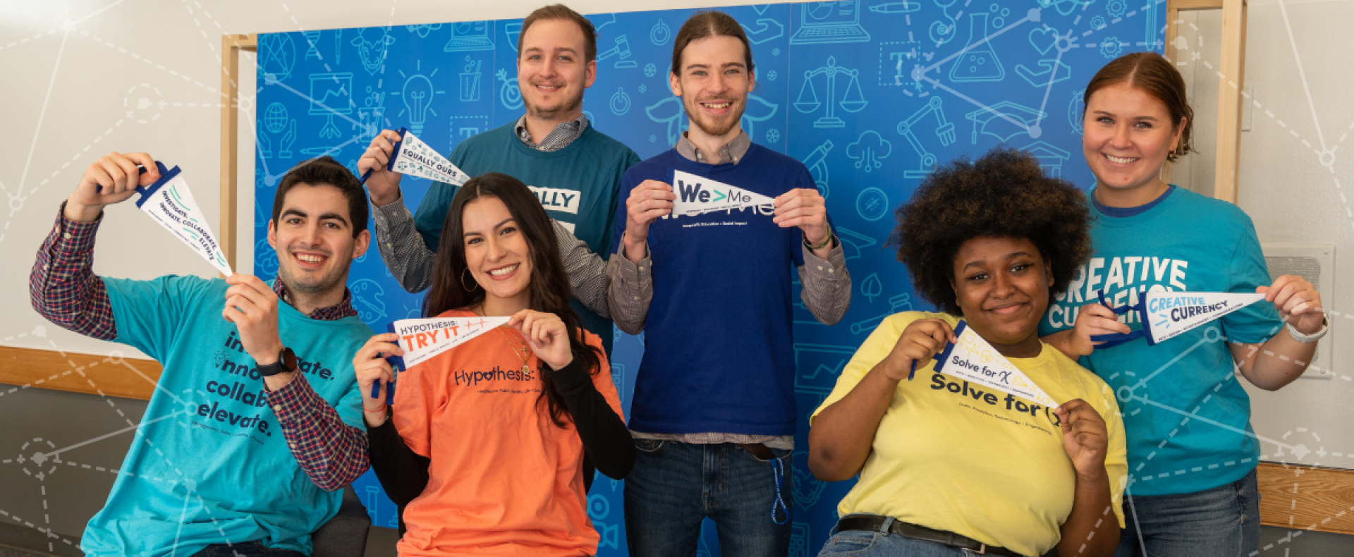 Six UB students holding Career Community pennants. 