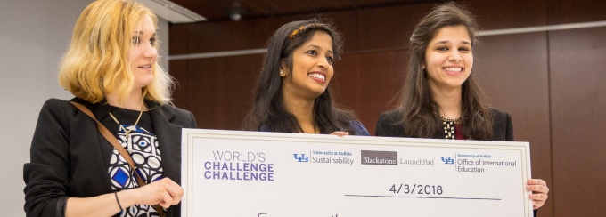 Students hold up their award. 