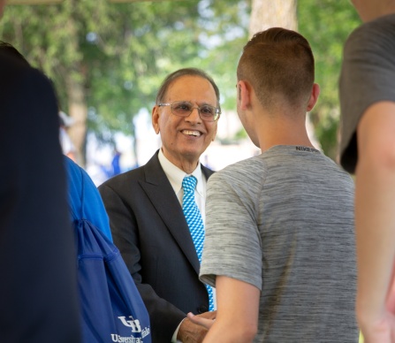 UB president greeting students. 