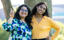 Two students smiling. 