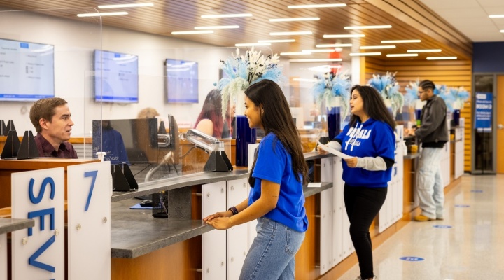 Students getting help at the 1Capen service counters. 