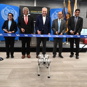 Preparing to cut the ribbon to open the National AI Institute for Exceptional Education are (from left) Sahana Rangasrinivasan, a computer science and engineering PhD candidate; NSF Director Sethuraman Panchanathan; U.S. Senate Majority Leader Chuck Schumer; President Satish K. Tripathi and Venu Govindaraju, vice president for research and economic development, and principal investigator of the AI institute. Photo: Nancy J. Parisi. 