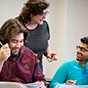 Professor Laura Chiesa teaching a course in Clemens Hall with two students seated in front of her. 