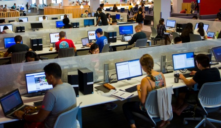 Interior of Silverman Library, students at computer stations. 