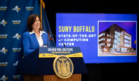 Governor Kathy Hochul stands at a podium announcing UB will be the home of Empire AI. Text: Empire AI @ UB. 