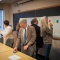 UB Provost Charles Zukoski joins in an exercise where faculty members write "wish list" items for email on post-it notes and categorize them by type of feature on large poster sheets. 